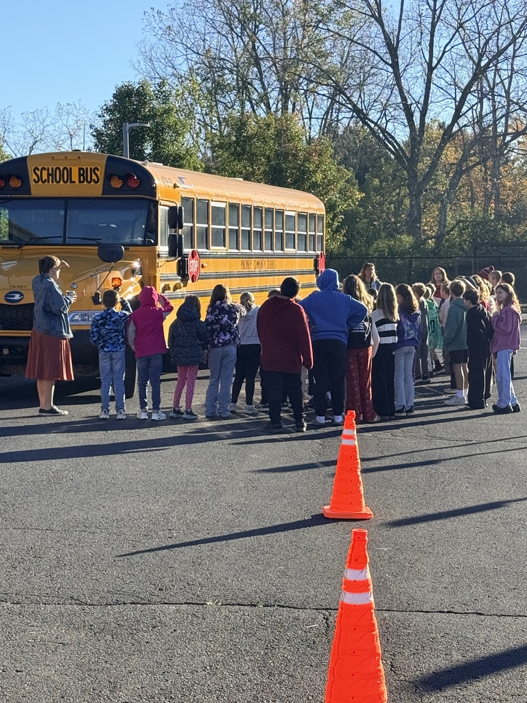 School bus with students around it 