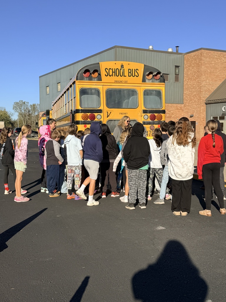 School bus with students around it 