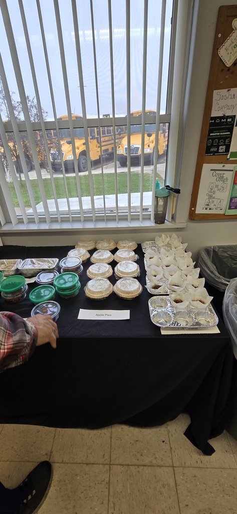 Baked goods individually packaged on a covered table for a bake sale. 
