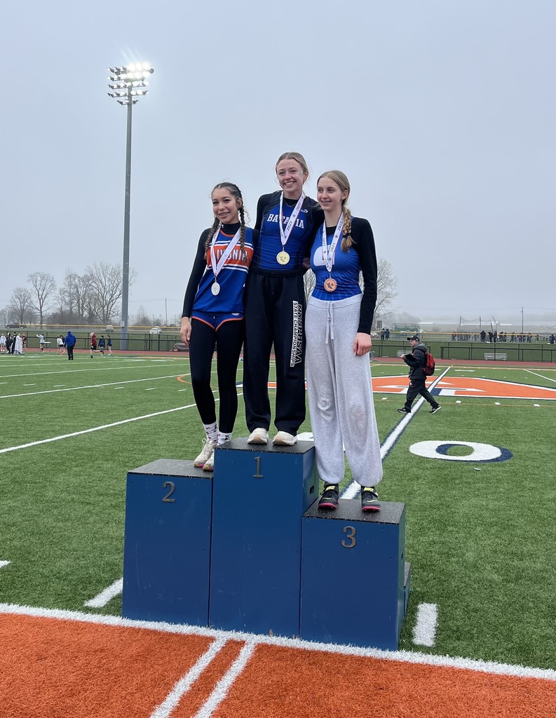 students on podium with medals