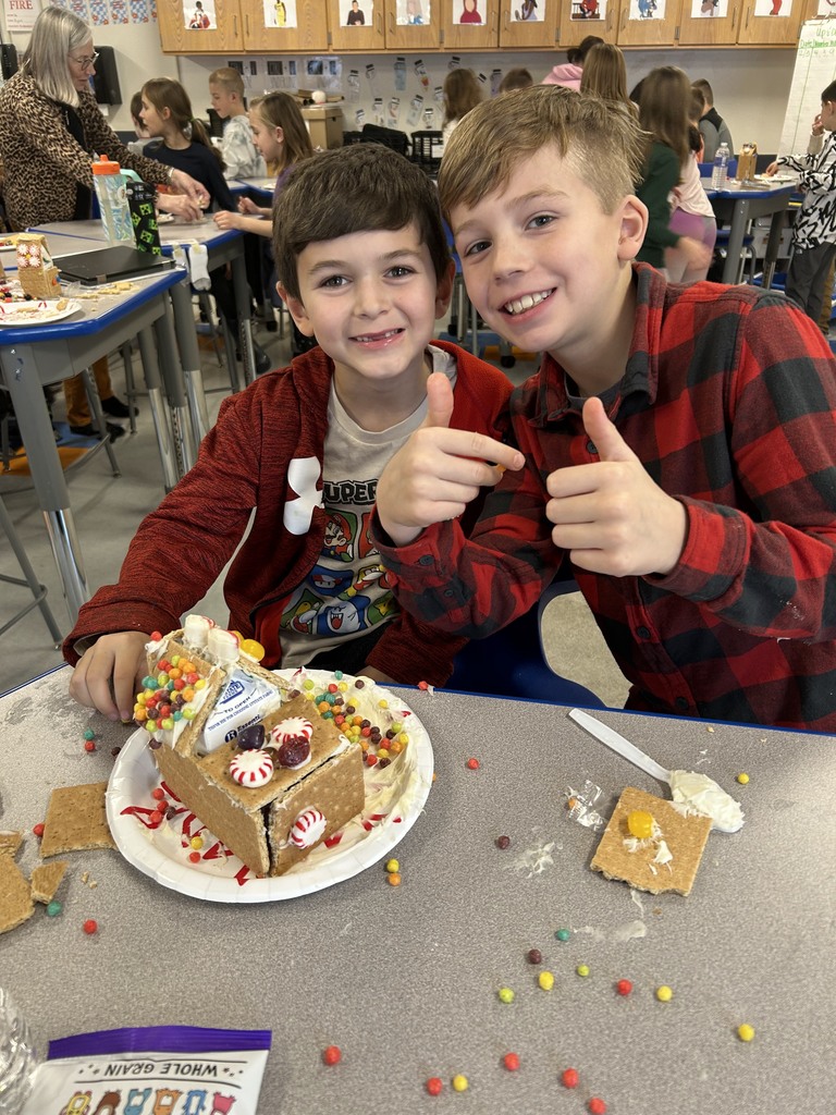 students with gingerbread house