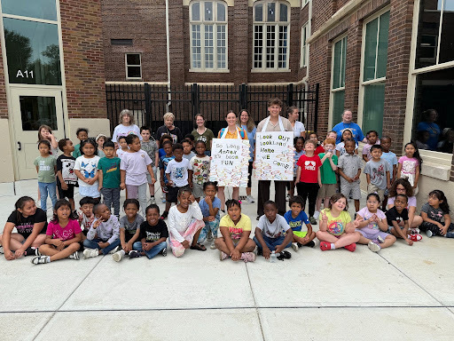 Students gathered for a group shot outside of the high school in a courtyard area