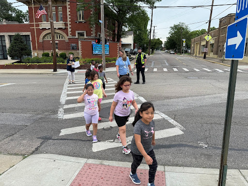 Students crossing the street to return to their school building after a visit to the main campus