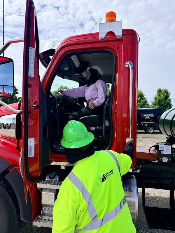 student behind steering wheel of truck