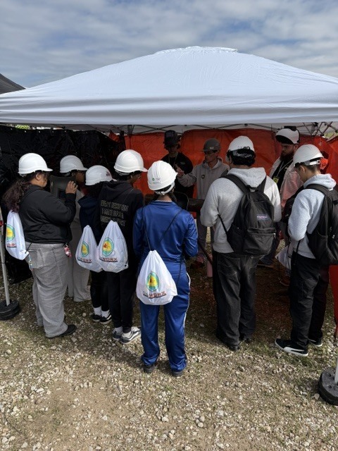 students listening near tent