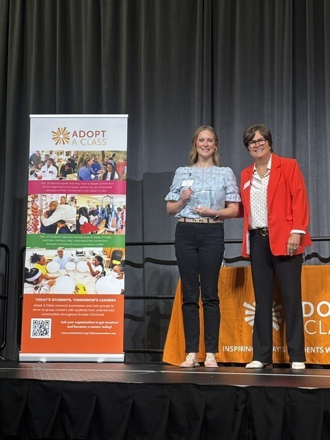 person on stage with award
