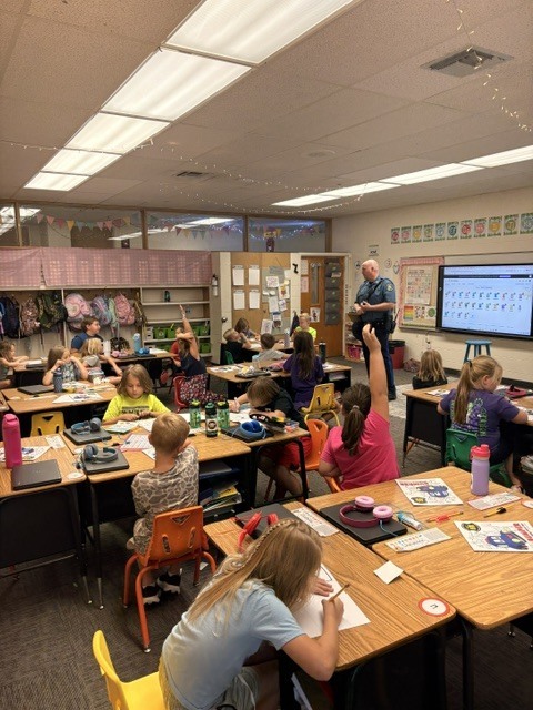 Elementary Students listening to Officer Jeffries
