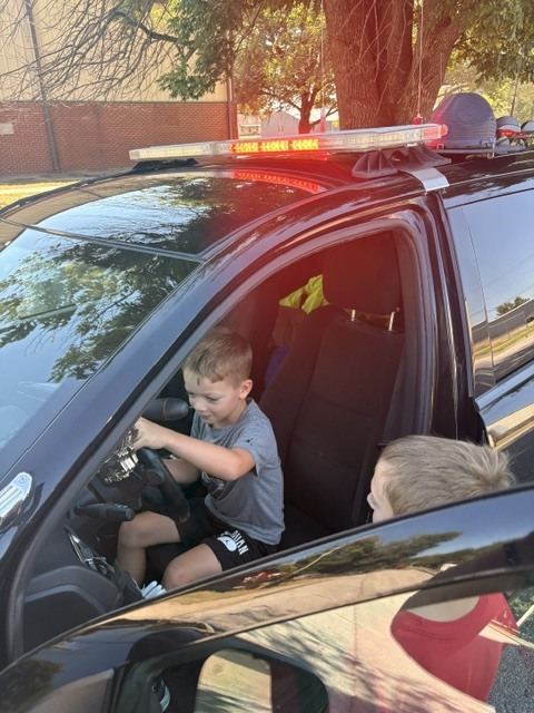 Elementary Student in Patrol Vehicle