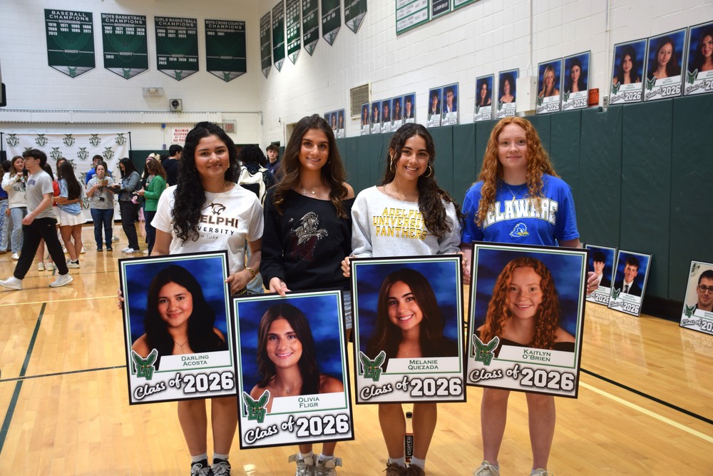 Seniors show off their signs from the Locust Valley High School Parents Council at Up & Away Day 2026.