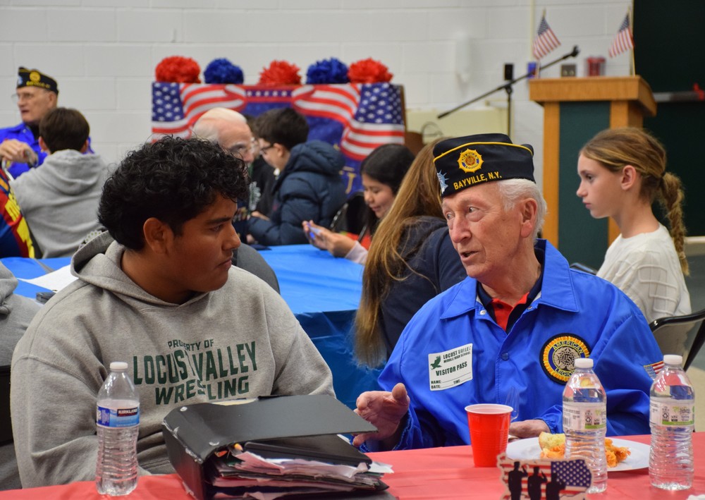 Locust Valley Middle School eighth grader Santiago Acosta spoke to a veteran from the Bayville American Legion post.