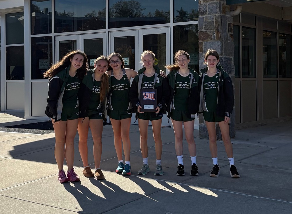 Members of the Locust Valley High School girls cross country team celebrate their return to the school after taking second place in the county championships on Nov. 1.
