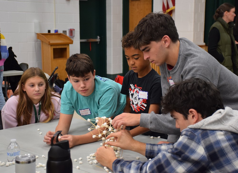 High schoolers and middle schoolers used teamwork to construct a tower using toothpicks and marshmallows.