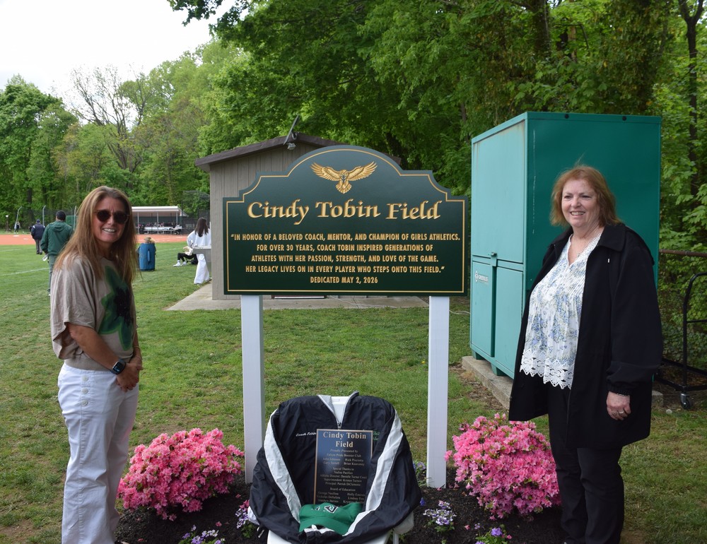 Nadine Pacifico and Wendy Tobin unveiled the sign commemorating the dedication of the Locust Valley High School softball field for legendary coach Cindy Tobin.