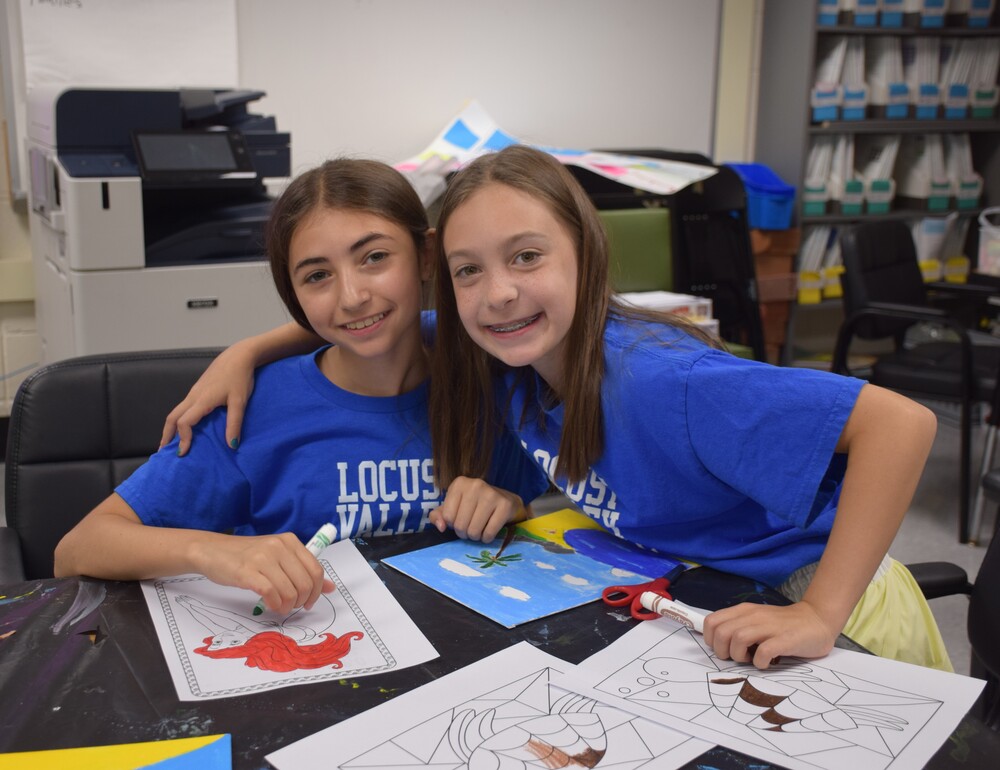 Summer Recreation campers make crafts with their counselor in July 2026.