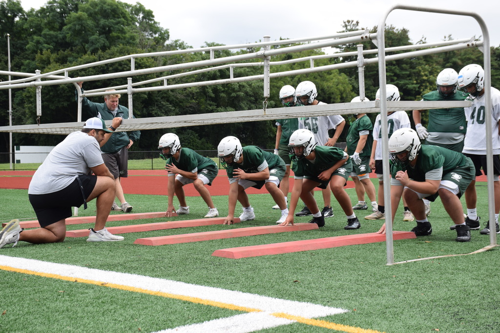 Coach Gilbert gets the offensive line ready for the season.