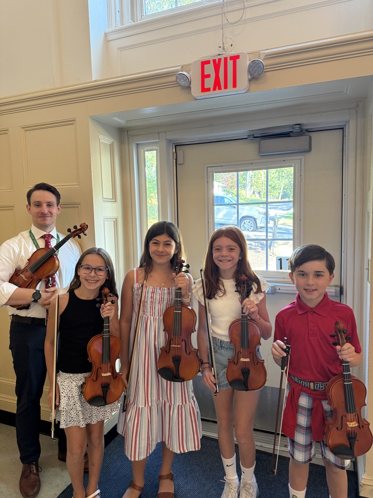 Bayville Intermediate’s Kassidy Lorner, Agatha Pillegi, Nina Orlowsky and Matthew Barnes (left to right) with music teacher Richard O’Flanagan after their Patriot Day performance.