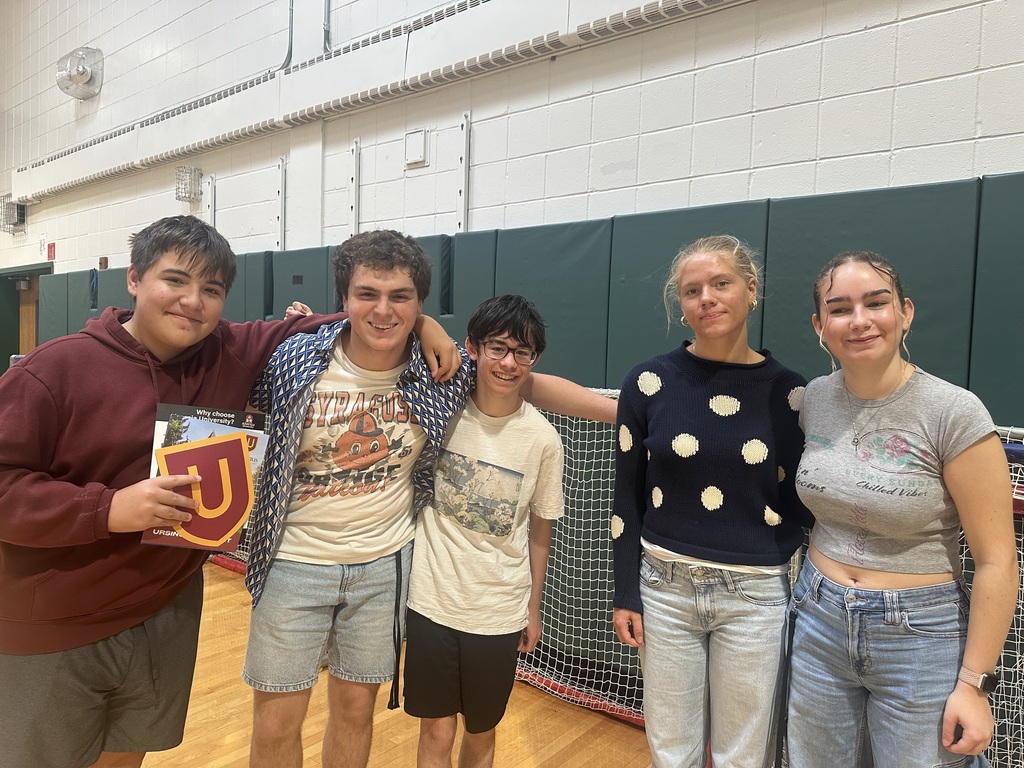 High schoolers enjoy going table to table with friends at the college fair.