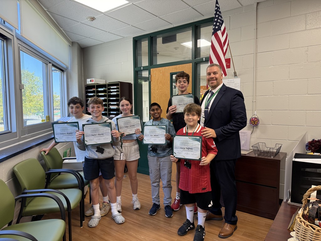 2) Locust Valley Middle School students (left to right) Jackson Shapses, Parker Charon, Fallyn Gorham, Eric Mohan, George Larice and George Hoffman are given their Caught Being Kind awards by Principal Michael Cestaro.