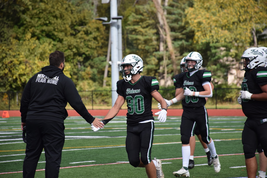 Coach Gilbert and the team celebrate a fumble recovery.