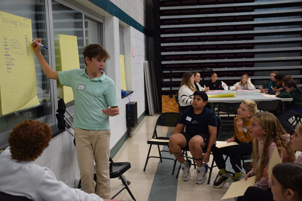 Sophomore Asher Zito lead middle and intermediate school students in an exercise on prioritization of goals.