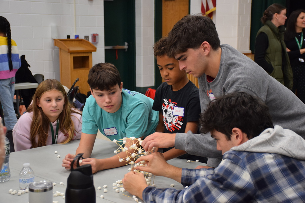 High schoolers and middle schoolers used teamwork to construct a tower using toothpicks and marshmallows.