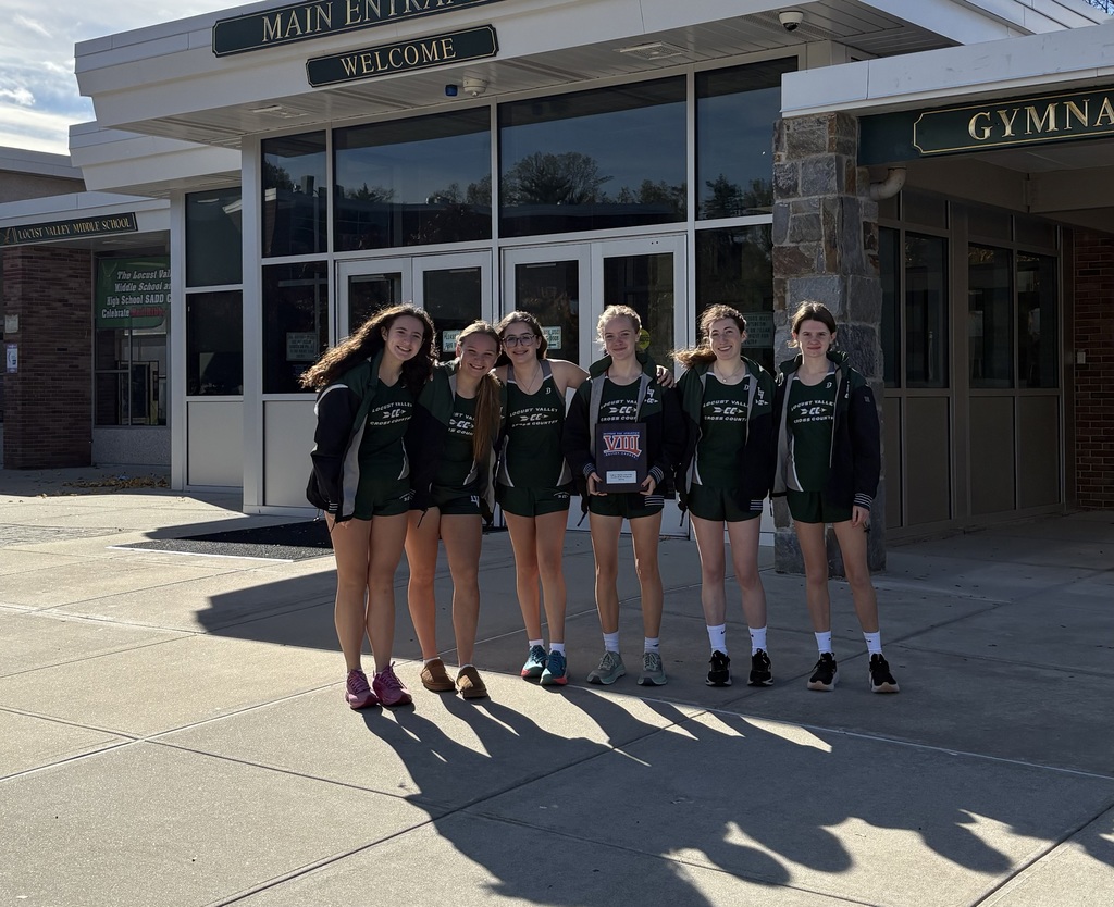 Members of the Locust Valley High School girls cross country team celebrate their return to the school after taking second place in the county championships on Nov. 1.