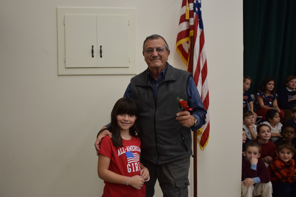 1)	Logan Zebrowski of Ann MacArthur Primary School gave her grandfather Jim Marapoti, a veteran, flowers for his service.