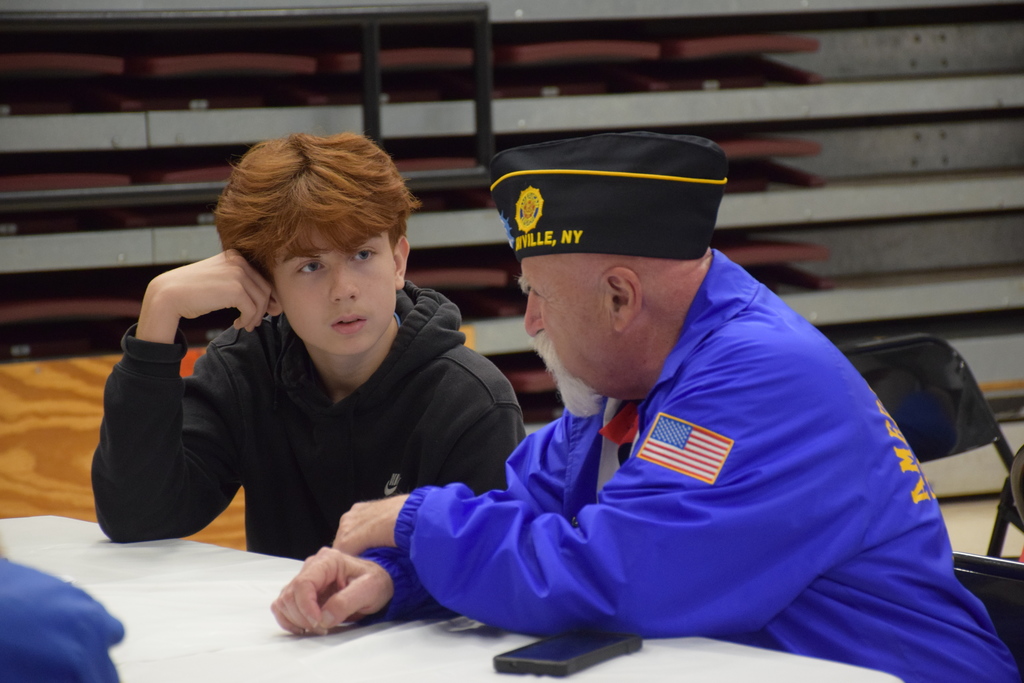 6)	Locust Valley Middle School eighth grader Aidan Gallagher listened to tales from a Bayville veteran.