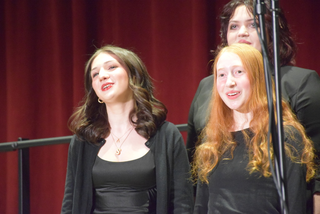 High school students Stella Fraser, Scarlett Modlin and Evie Bergman perform in the chrous.