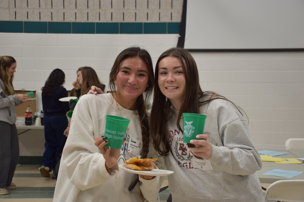 Locust Valley High School alumnae Sienna Singe (left) and Grace O’Mahony (right) reconnect at the IB alumni event on Dec. 22.
