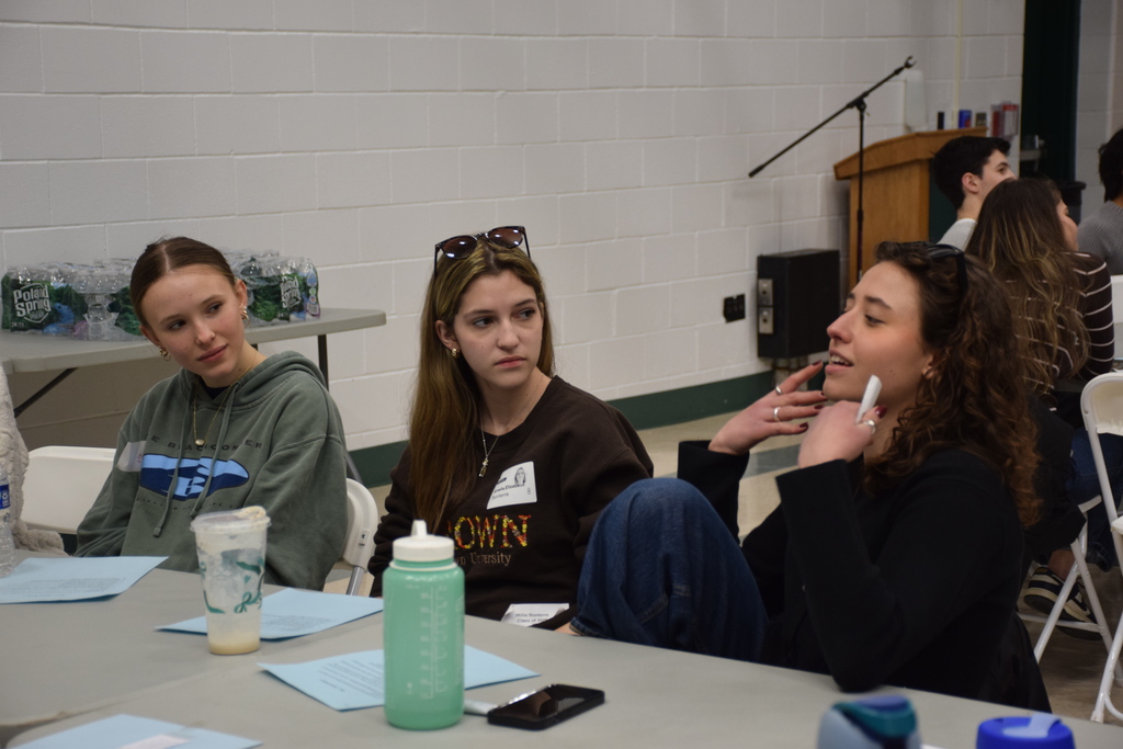 Locust Valley High School alumni Sophia Del Guidice (right) and Millie Bonterre (center) discuss the benefits of the IB program in their college years with current student Grace McDonald.