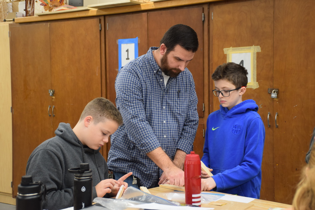 Mr. Labansky helps a student with his project.