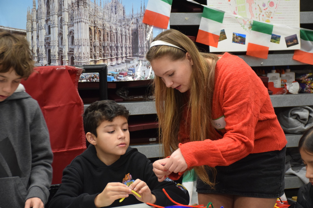 Locust Valley High School student Riley Iannotti helped students create Italian-themed arts and crafts.