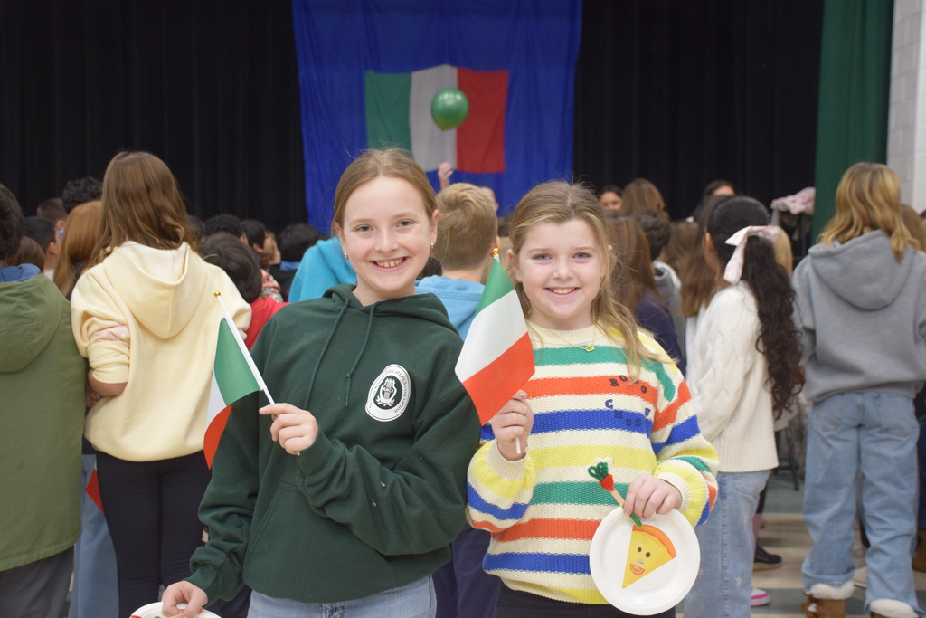 Locust Valley Intermediate students Holden Higgs and Hadley Austin waved Italian flags as they departed Italiamo.
