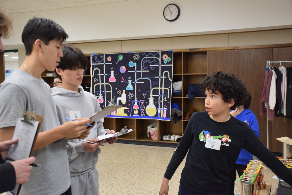Ramon Martinez presents his project "Rubik's Cube Materials" to the high school judges.
