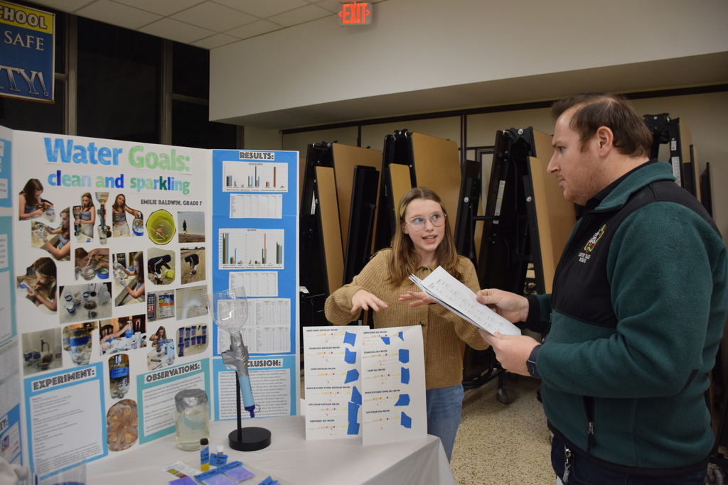 Emilie Baldwin presents her project to Mr. DeRose.