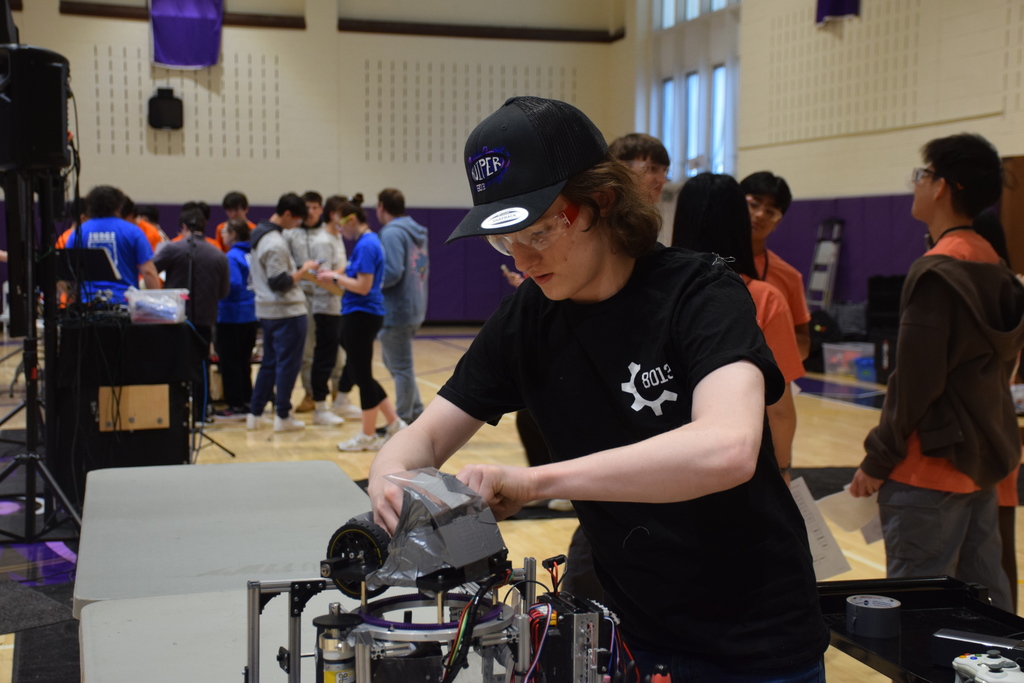 Locust Valley High School student Dylan Robson made repairs to their robot on the fly.