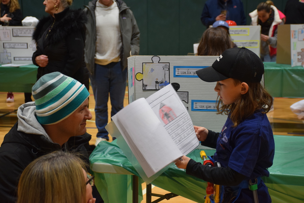 A Bayville Primary second grader explains the plumbing profession to a guest.