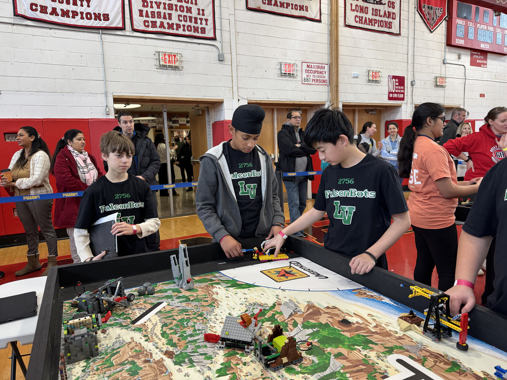 Locust Valley Middle School students Jason Eisenberg, Jeet Gadh and Matthew Lu prepared their robot for the next event.