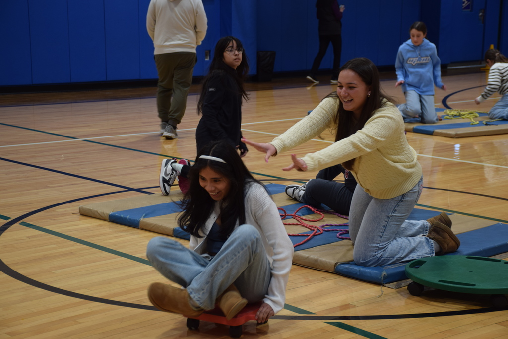 Locust Valley High School student Eva Jaszczuk propelled classmate Daniela Cruz at Bayville Intermediate School on a scooter after reading to students.