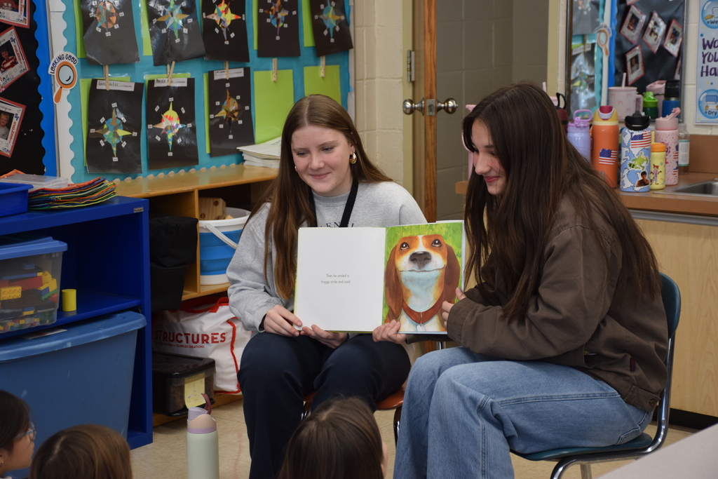 Locust Valley High Schoolers Abby Madden and Mia Marcantonio read to Bayville Primary School second graders.