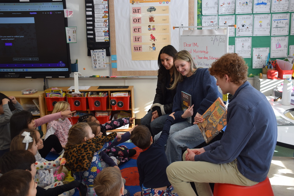 Locust Valley High School students Cristina Villella, Ryan Croke and Jordan Sullivan read “Good-Night, Owl!” by Pat Hutchins to Ann MacArthur Primary School students.