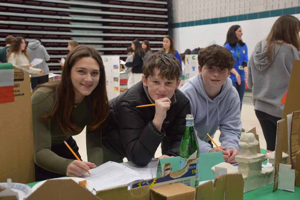 Middle school Italian class students roam learn more about another region at another display.