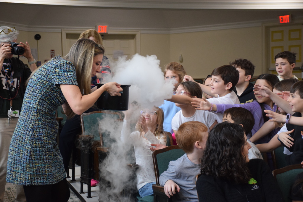 LVI students grasp at the clouds created by dry ice.