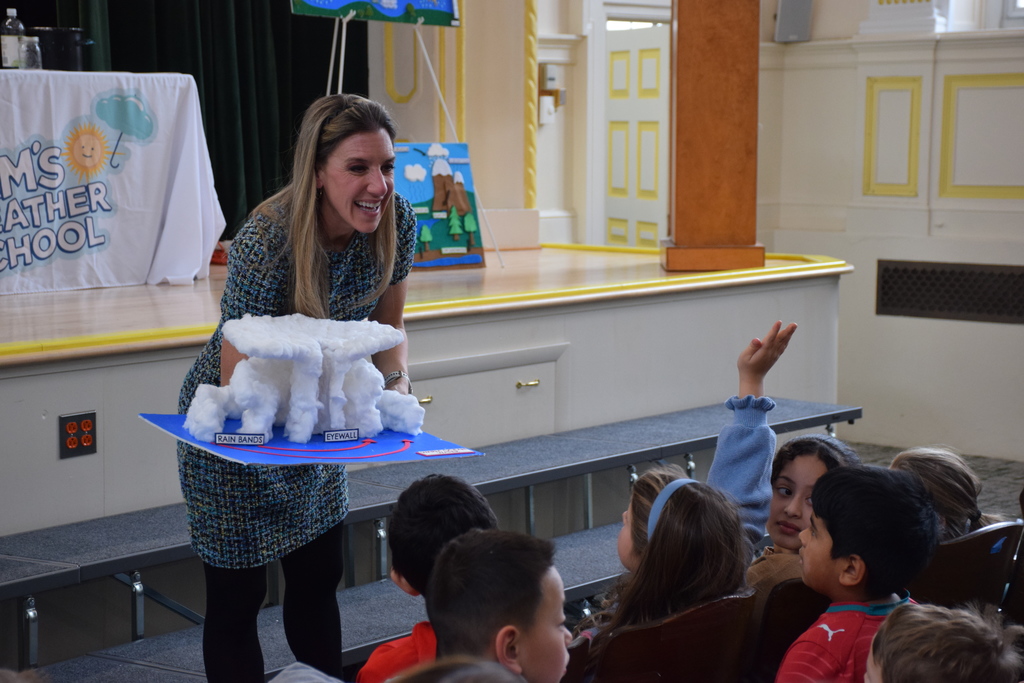 Samantha Augeri shows LVI third graders a diorama of a hurricane system.