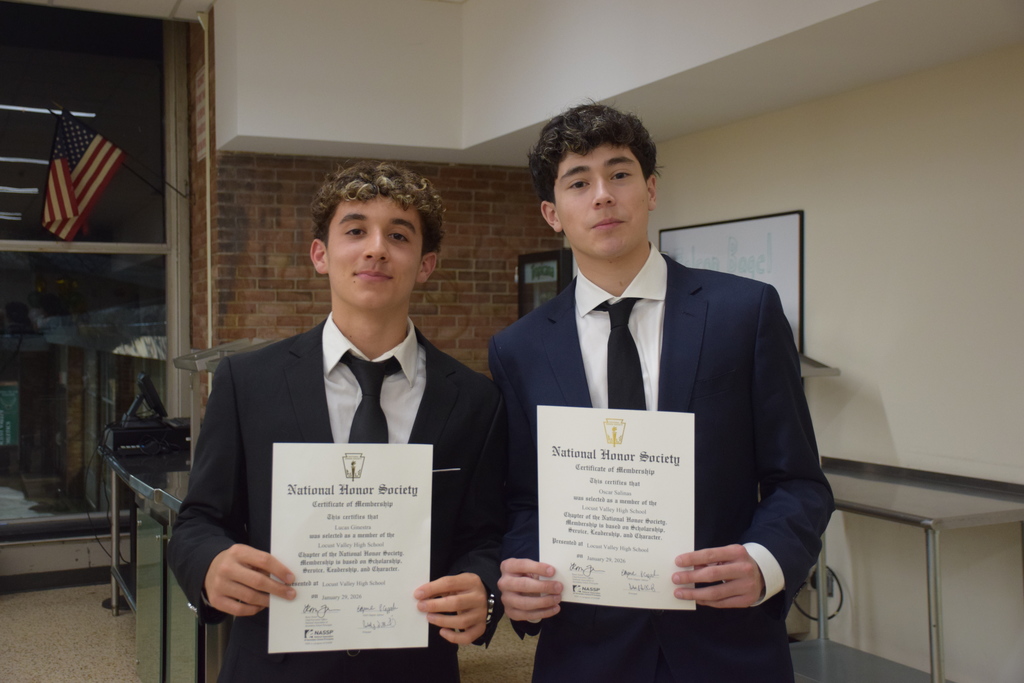 Two new inductees show their diploma.