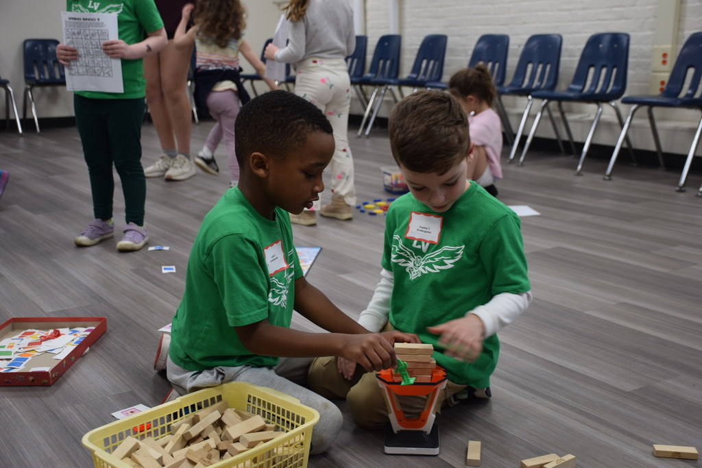 Two young students play with wood blocks on Unplugged Night 2026