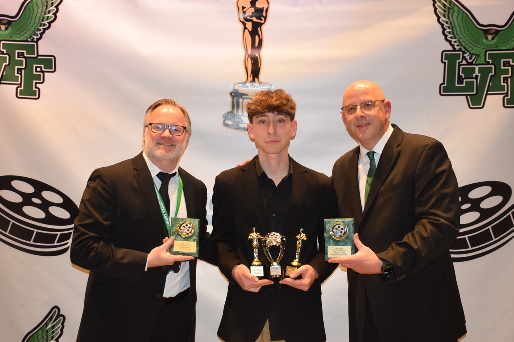 Locust Valley film teachers Jacob Cooney (left) and Roger Boucher (right) with high school student Joseph Esposito, who won the commercial category for “Wall Street Barber.”