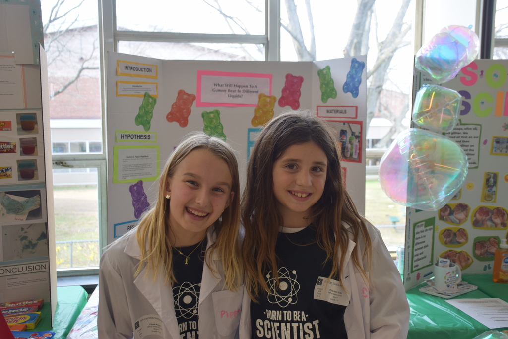 LVI's Pippa Munsill and Charlotte DiLollo with their project: "What Melts Gummy Bears?"