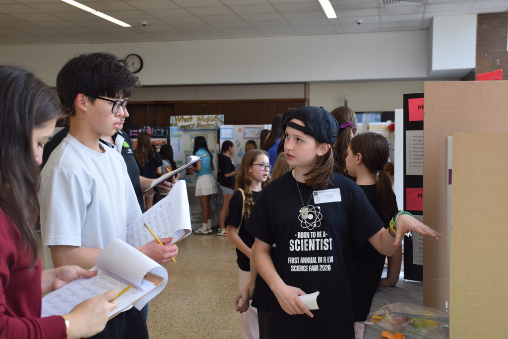 BI fifth grader Kaylee Hallock explains her project to a high school judge.